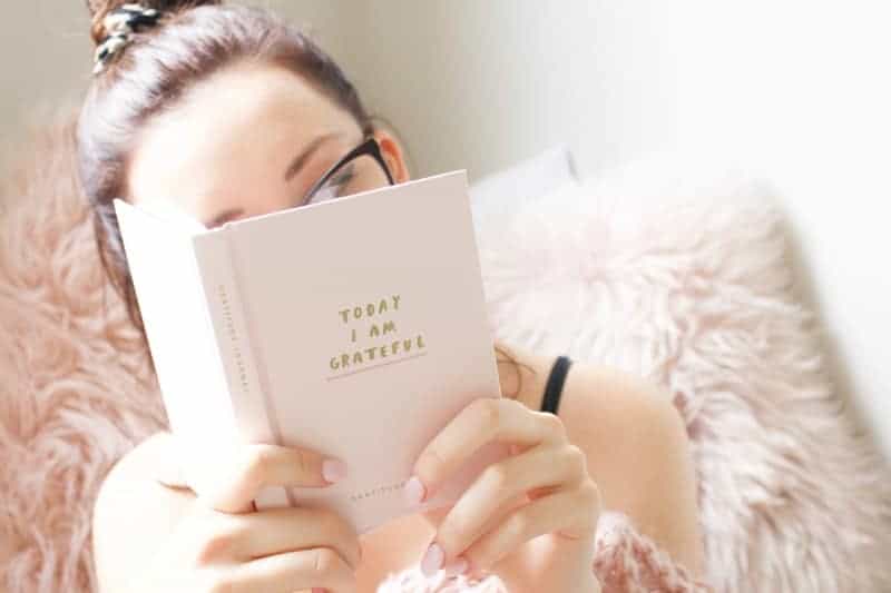 girl reading gratitude journal